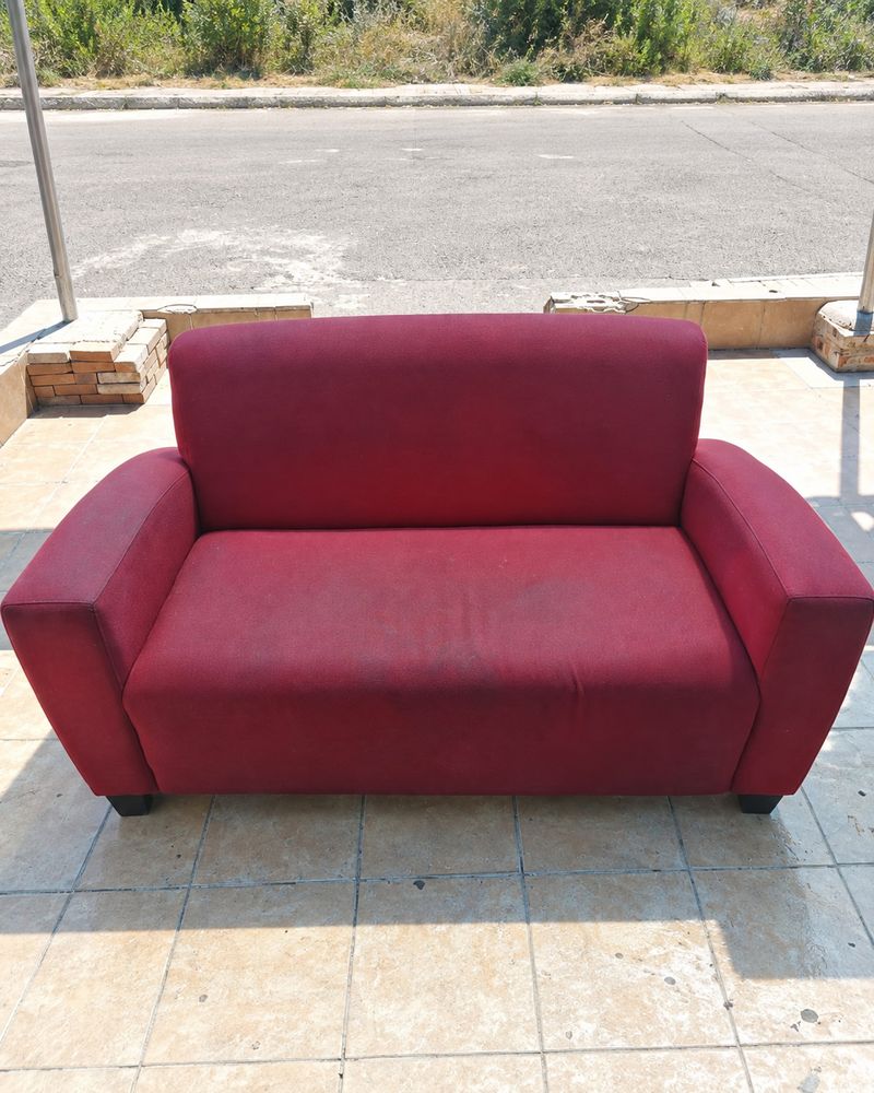 Red fabric couch dull and stained before cleaning